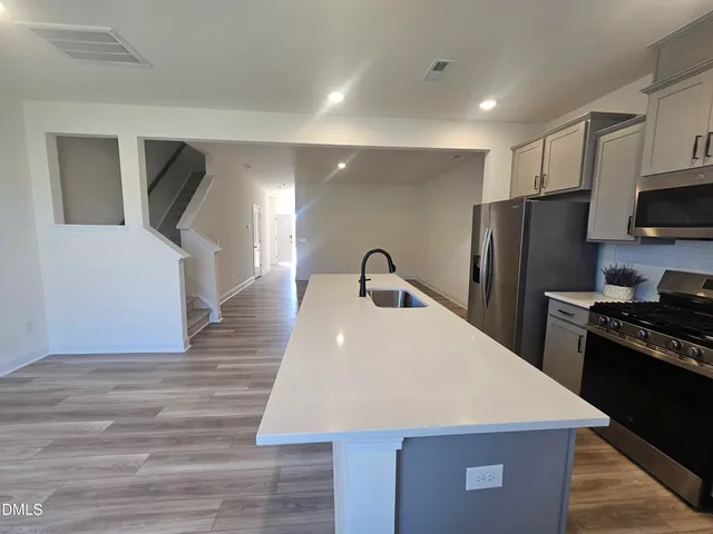 a kitchen with refrigerator and stove