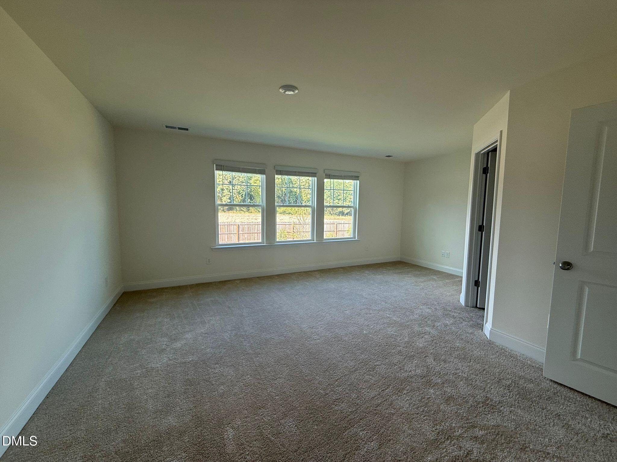 66 Bloodroot Street Angier, NC 27501 - Photo 9 of 16 an empty room with a window