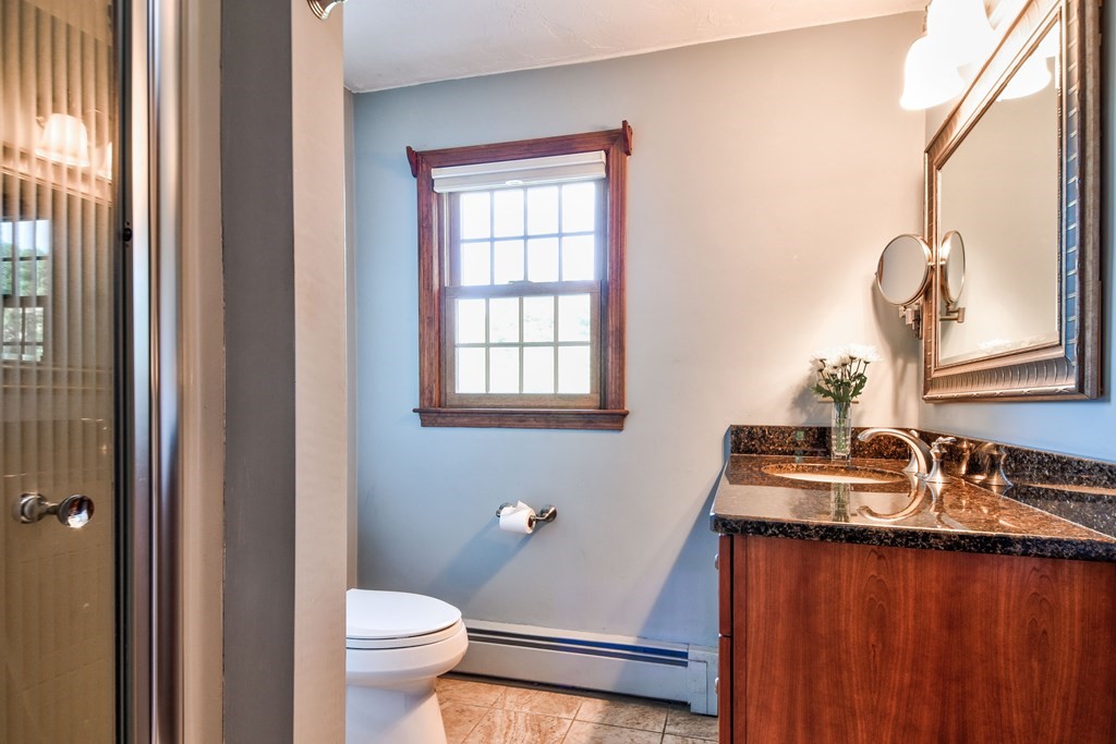 6 Dale Road Hopkinton, MA 01748 - Photo 29 of 39 a bathroom with a granite countertop sink a toilet and a mirror