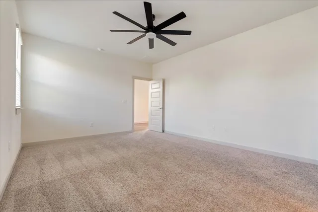 an empty room with a empty space and a ceiling fan