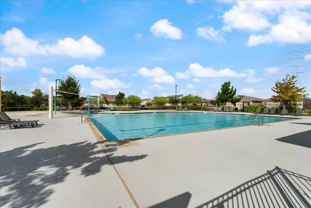 a view of swimming pool and lake from a window