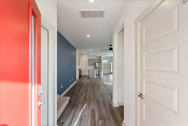 a view of hallway with wooden floor