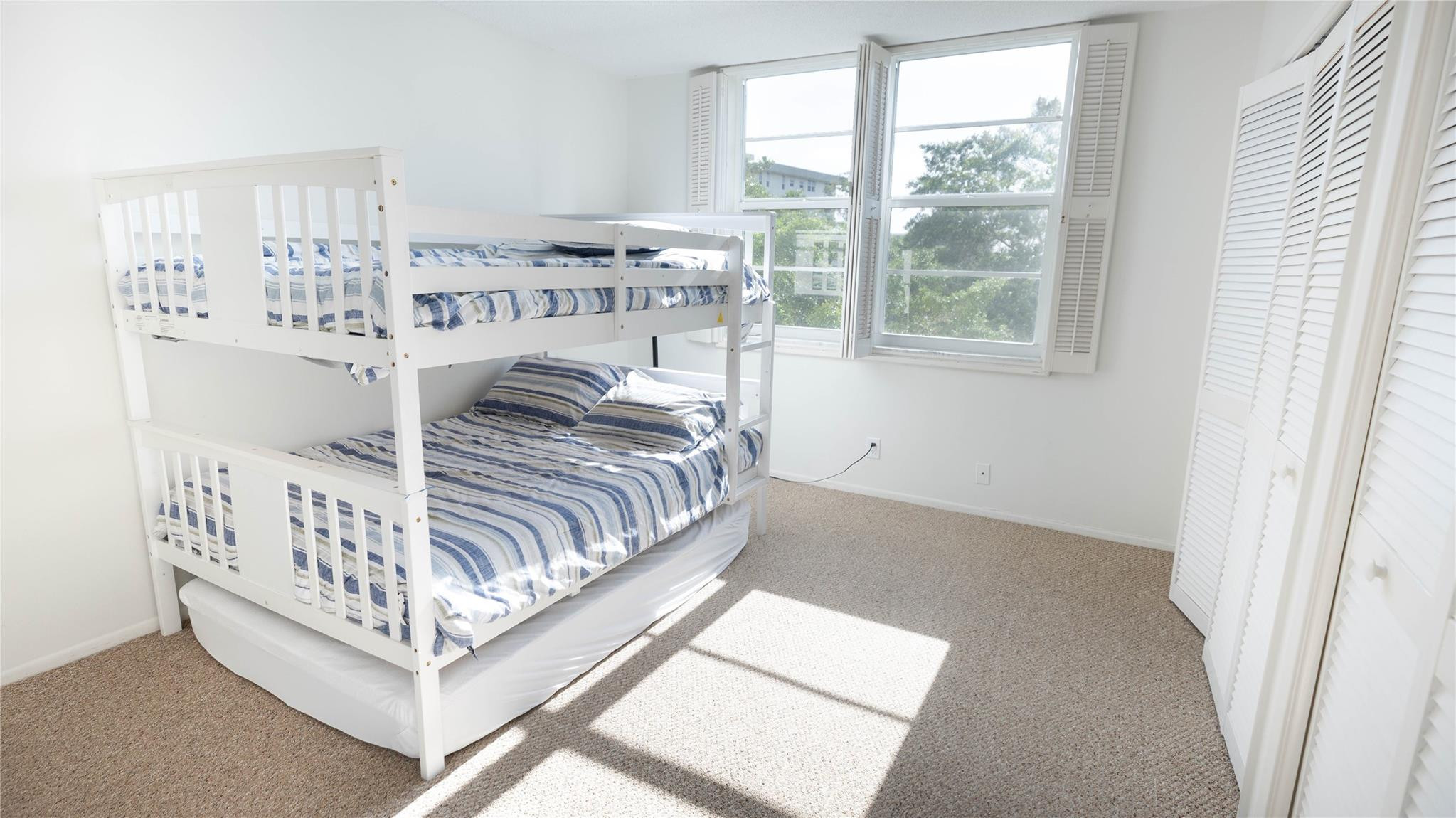 3100 North Course Lane, Unit 510 Pompano Beach, FL 33069 - Photo 15 of 21 a bed sitting in a bedroom next to a window