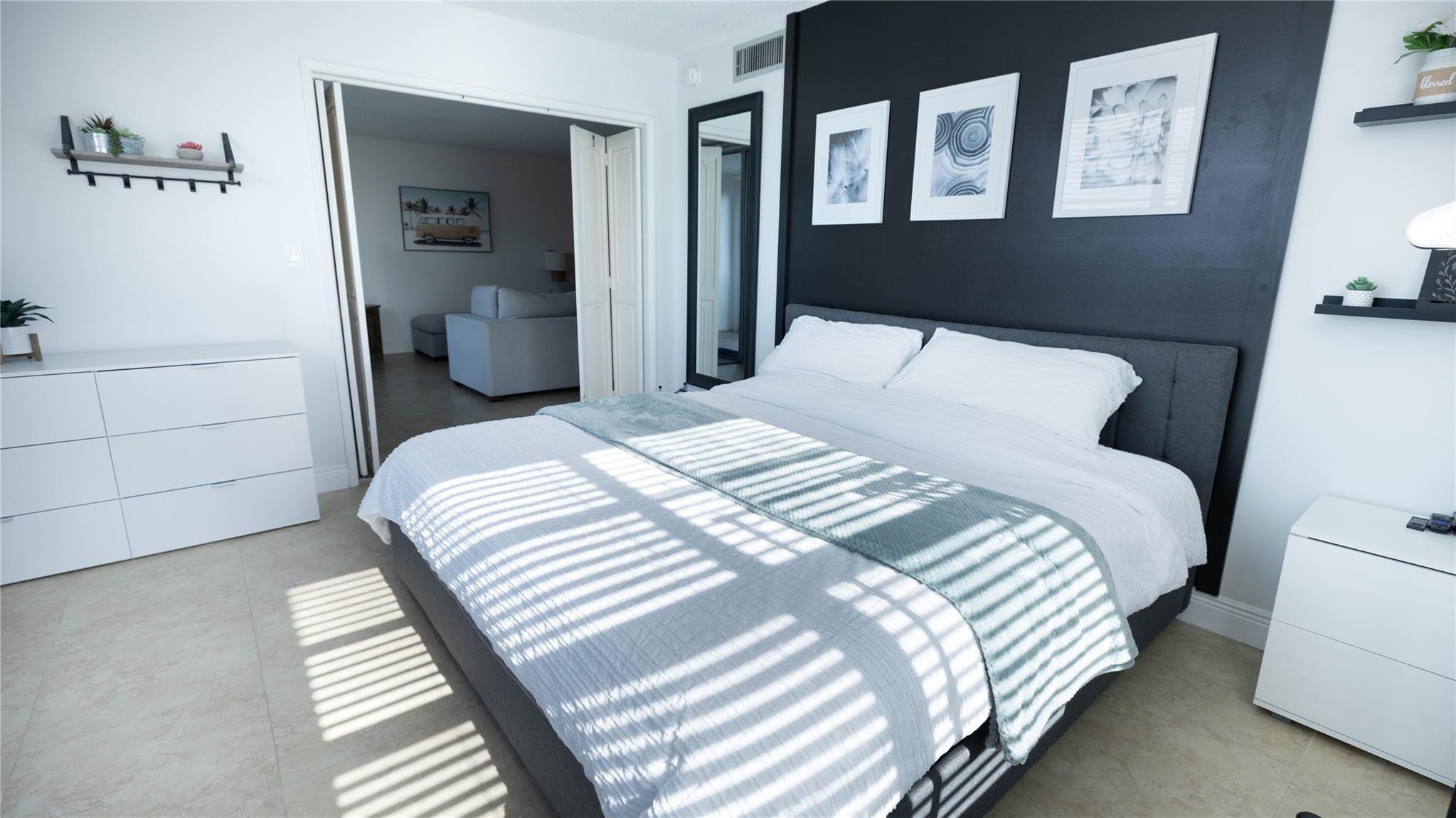 3100 North Course Lane, Unit 510 Pompano Beach, FL 33069 - Photo 19 of 21 a bedroom with a bed and a lamp on dresser