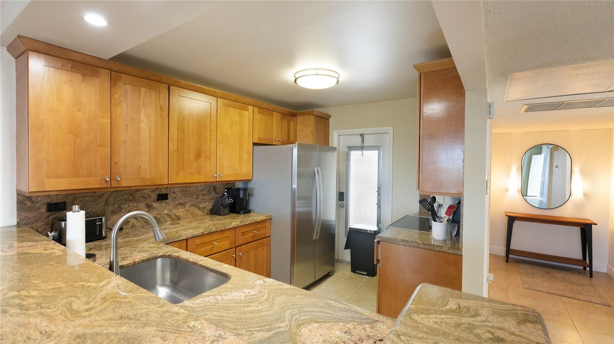 3100 North Course Lane, Unit 510 Pompano Beach, FL 33069 - Photo 4 of 21 a kitchen with granite countertop a refrigerator and a sink
