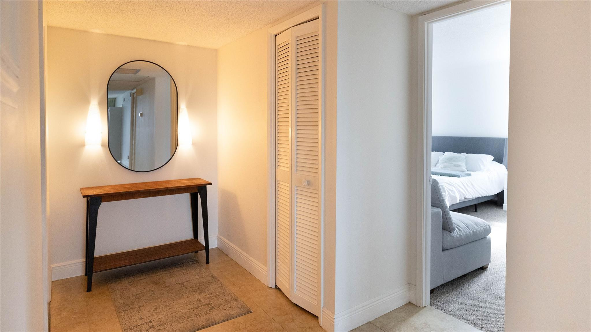 3100 North Course Lane, Unit 510 Pompano Beach, FL 33069 - Photo 8 of 21 a room with wooden floor and a mirror