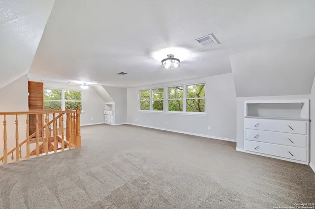 an empty room with windows and closet