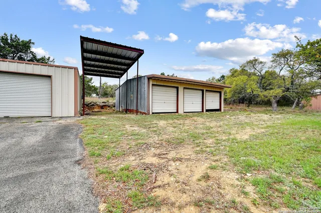 a backyard of a house with table and chairs