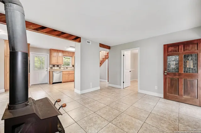 a view of a kitchen with furniture and an empty room