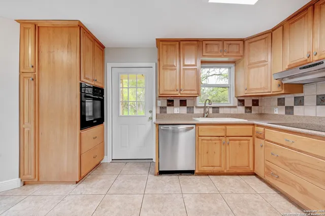 a kitchen with stainless steel appliances granite countertop a refrigerator sink and cabinets