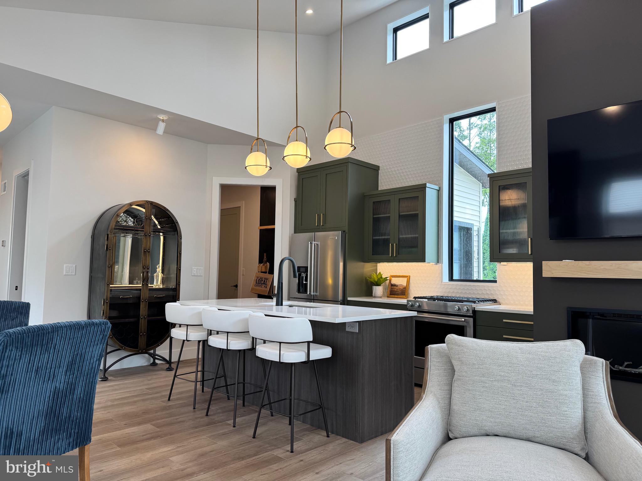 256 South Cedar Street Lititz, PA 17543 - Photo 14 of 25 a living room with furniture a chandelier and a flat screen tv