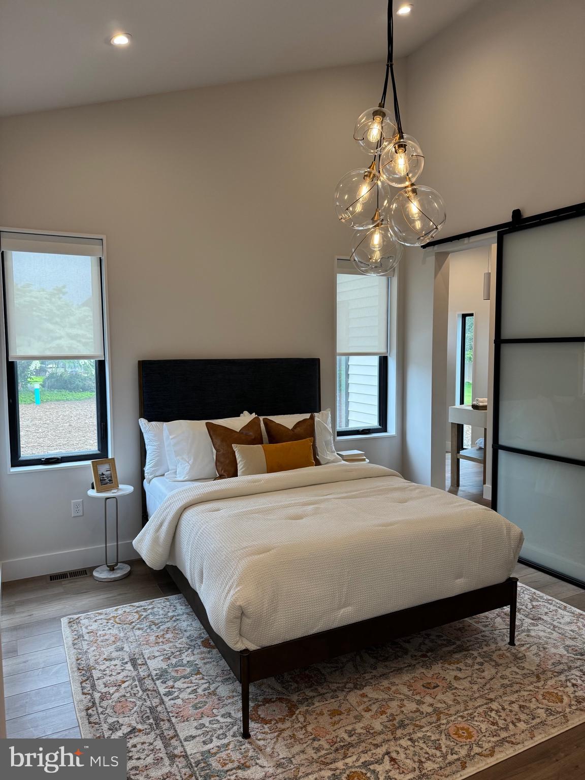 256 South Cedar Street Lititz, PA 17543 - Photo 22 of 25 a bedroom with a large bed chandelier and a window