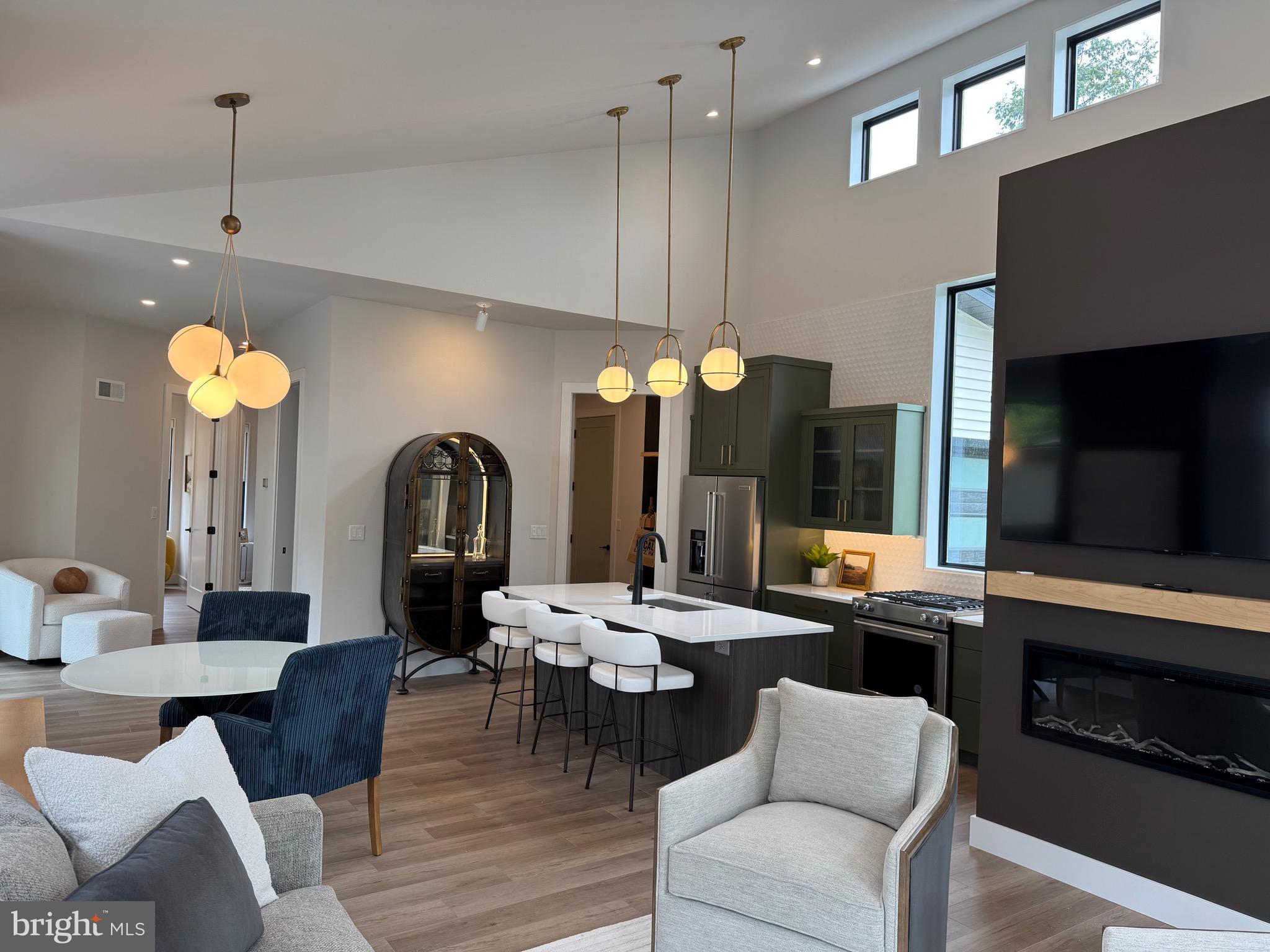 256 South Cedar Street Lititz, PA 17543 - Photo 5 of 25 a living room with furniture a flat screen tv and kitchen view