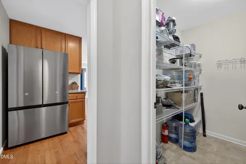 a kitchen with a refrigerator and cabinets