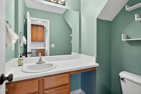 a bathroom with a sink and a mirror with toilet