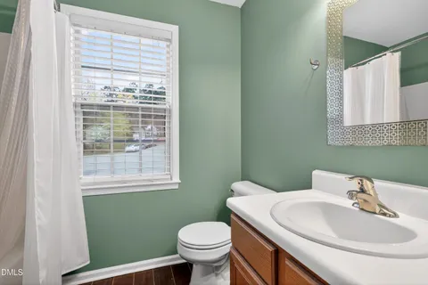 a bathroom with a sink toilet and mirror