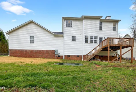 a view of a house with a yard and sitting area