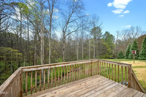 a view of balcony with wooden floor and fence