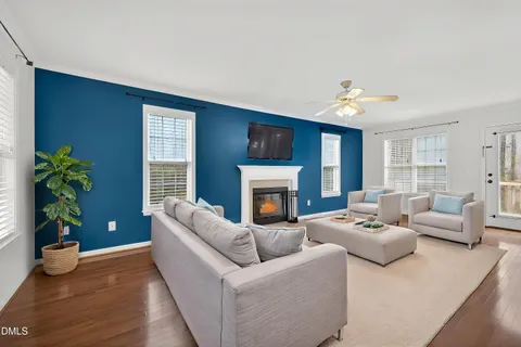 a living room with furniture potted plant and a fireplace
