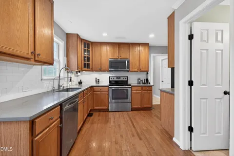 a kitchen with stainless steel appliances a refrigerator and a sink