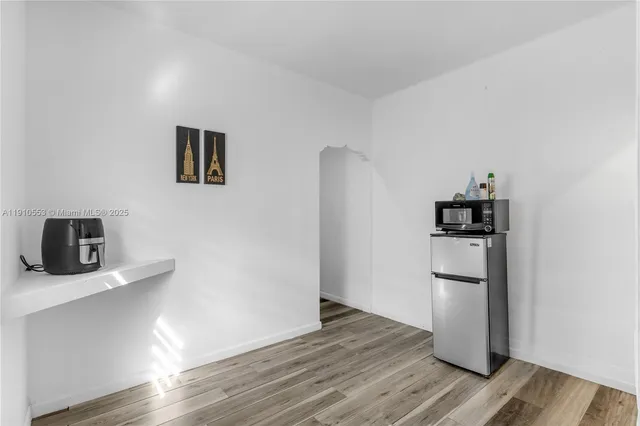 a kitchen with a refrigerator and a microwave