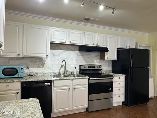 a kitchen with a sink a stove and refrigerator