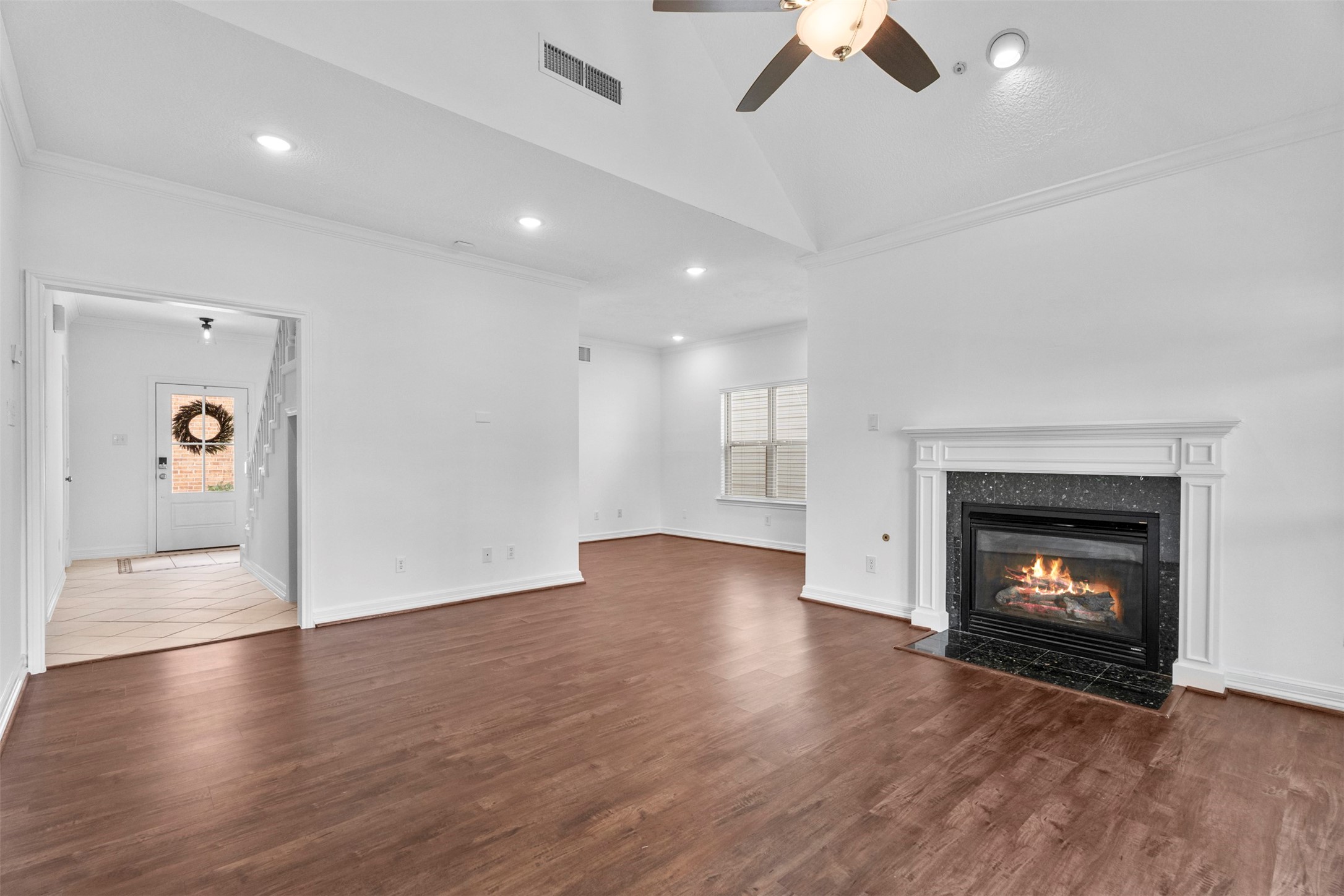 7635 Ameswood Road Houston, TX 77095 - Photo 7 of 39 Family room with vaulted ceilings, fireplace and gorgeous vinyl floors.
