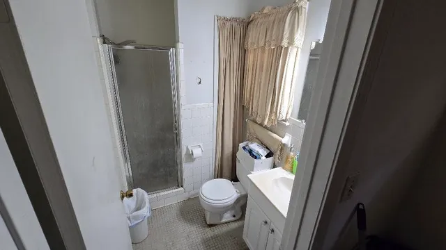 a white toilet sitting next to a bathroom sink