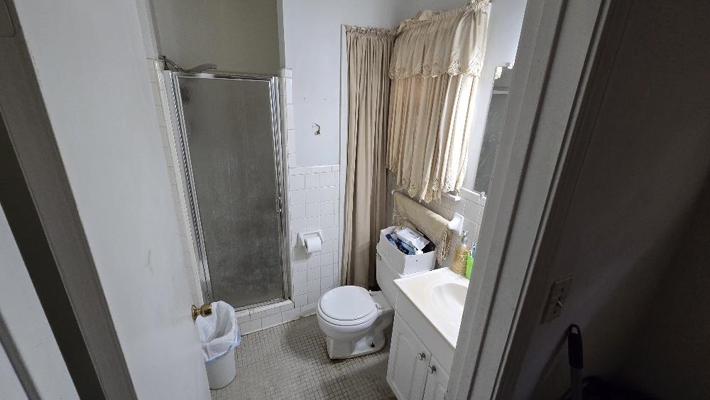 3162 Ford Road Memphis, TN 38109 - Photo 11 of 17 a white toilet sitting next to a bathroom sink
