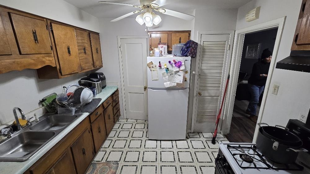 3162 Ford Road Memphis, TN 38109 - Photo 10 of 17 a kitchen with stainless steel appliances granite countertop a sink stove and refrigerator