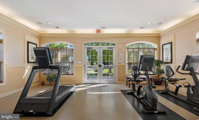 a room with gym equipment and a large window
