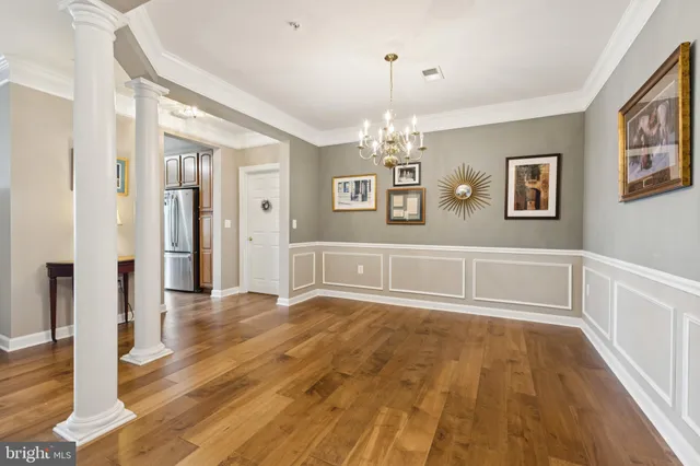 a view of a livingroom with a furniture wooden floor and chandelier