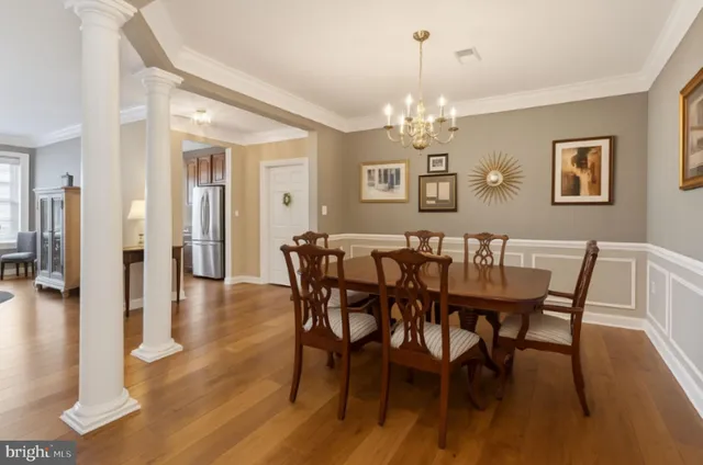 a view of a dining room with furniture wooden floor and chandelier