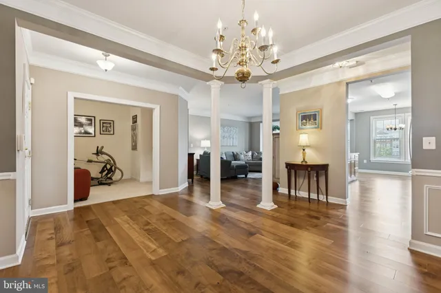 a view of a dining room with furniture and a chandelier
