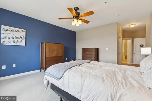 a bedroom with a bed and ceiling fan