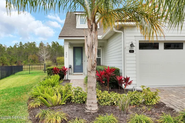 a kitchen with a sink refrigerator and cabinets