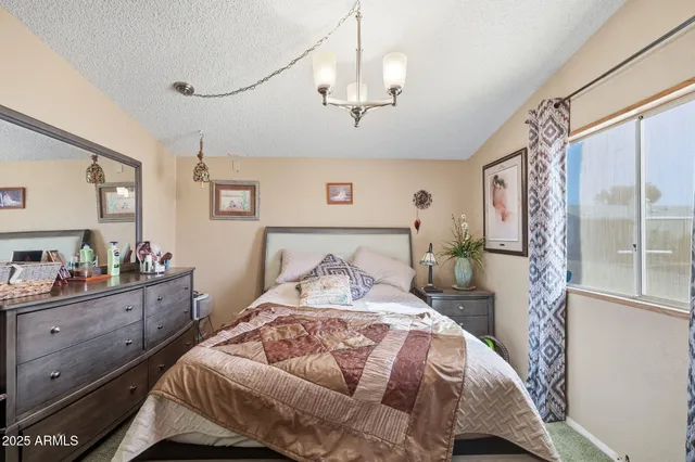 a bedroom with a large bed and a window