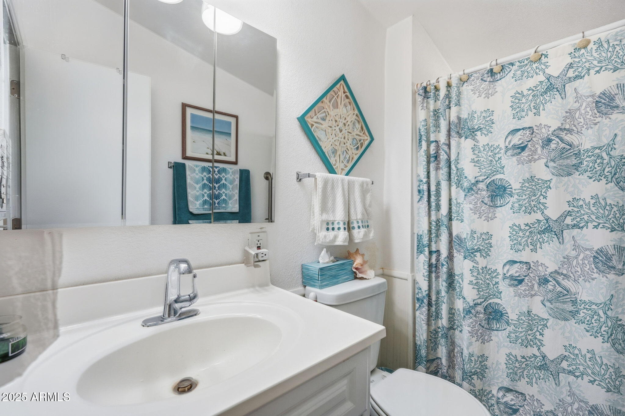 1925 South Arizona Boulevard, Unit 141 Coolidge, AZ 85128 - Photo 12 of 19 a bathroom with a toilet sink and mirror