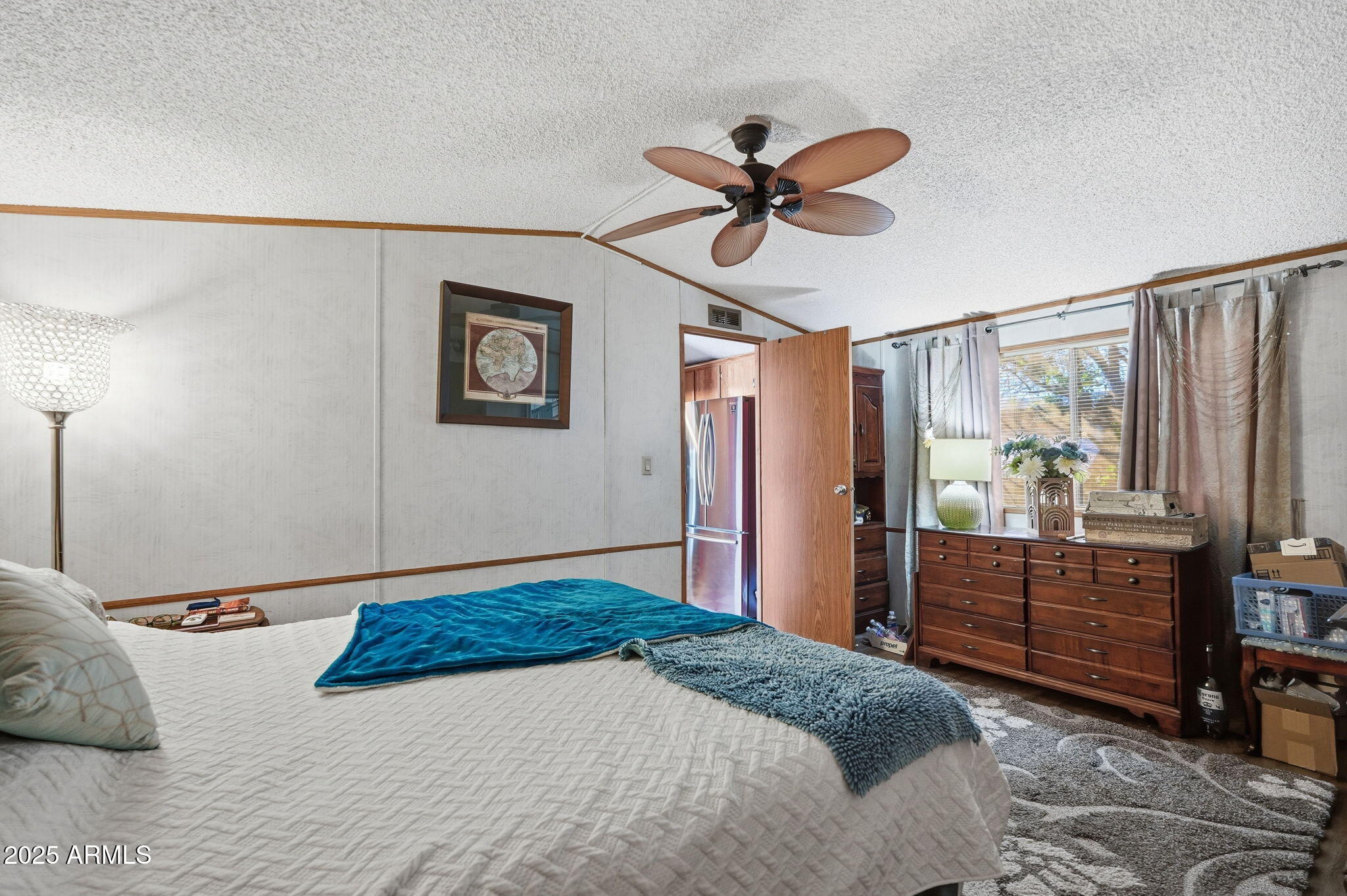 1925 South Arizona Boulevard, Unit 141 Coolidge, AZ 85128 - Photo 14 of 19 a bedroom with a bed and a chandelier