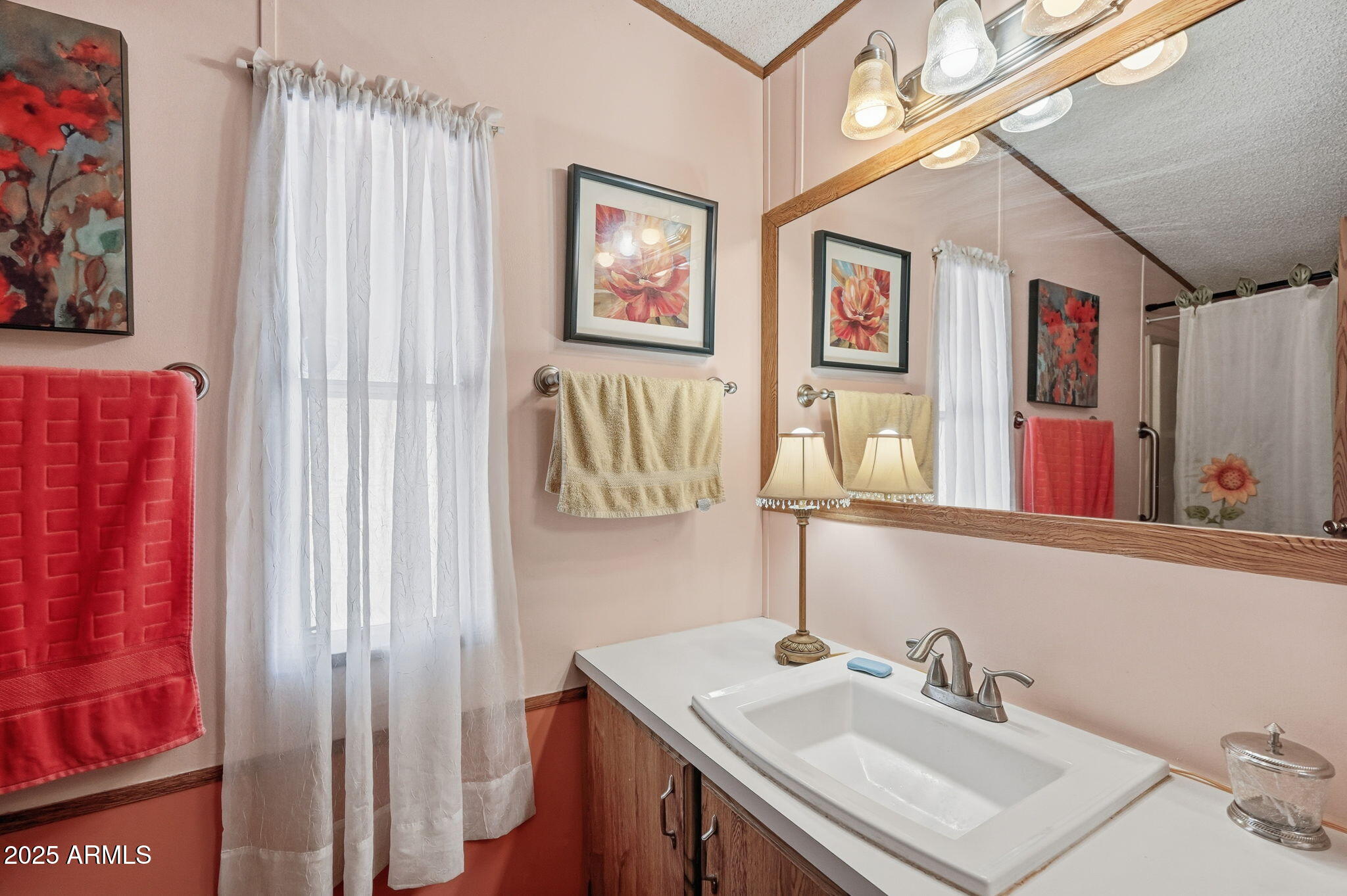 1925 South Arizona Boulevard, Unit 141 Coolidge, AZ 85128 - Photo 16 of 19 a bathroom with a sink vanity and mirror