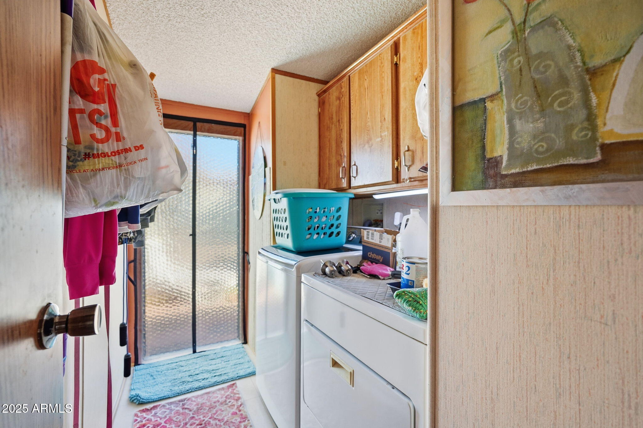 1925 South Arizona Boulevard, Unit 141 Coolidge, AZ 85128 - Photo 18 of 19 a kitchen with a refrigerator and cabinets