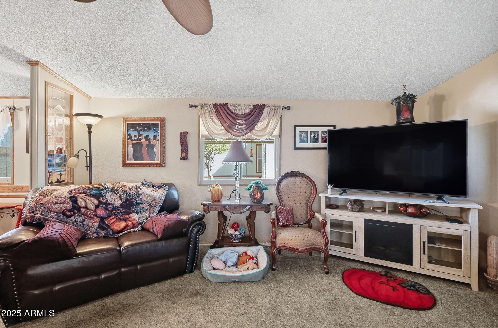 1925 South Arizona Boulevard, Unit 141 Coolidge, AZ 85128 - Photo 4 of 19 a living room with furniture and a flat screen tv
