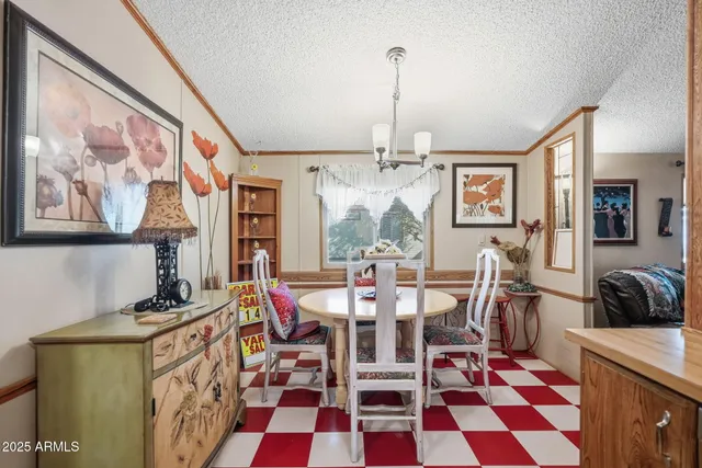 a view of a dining room with furniture and chandelier