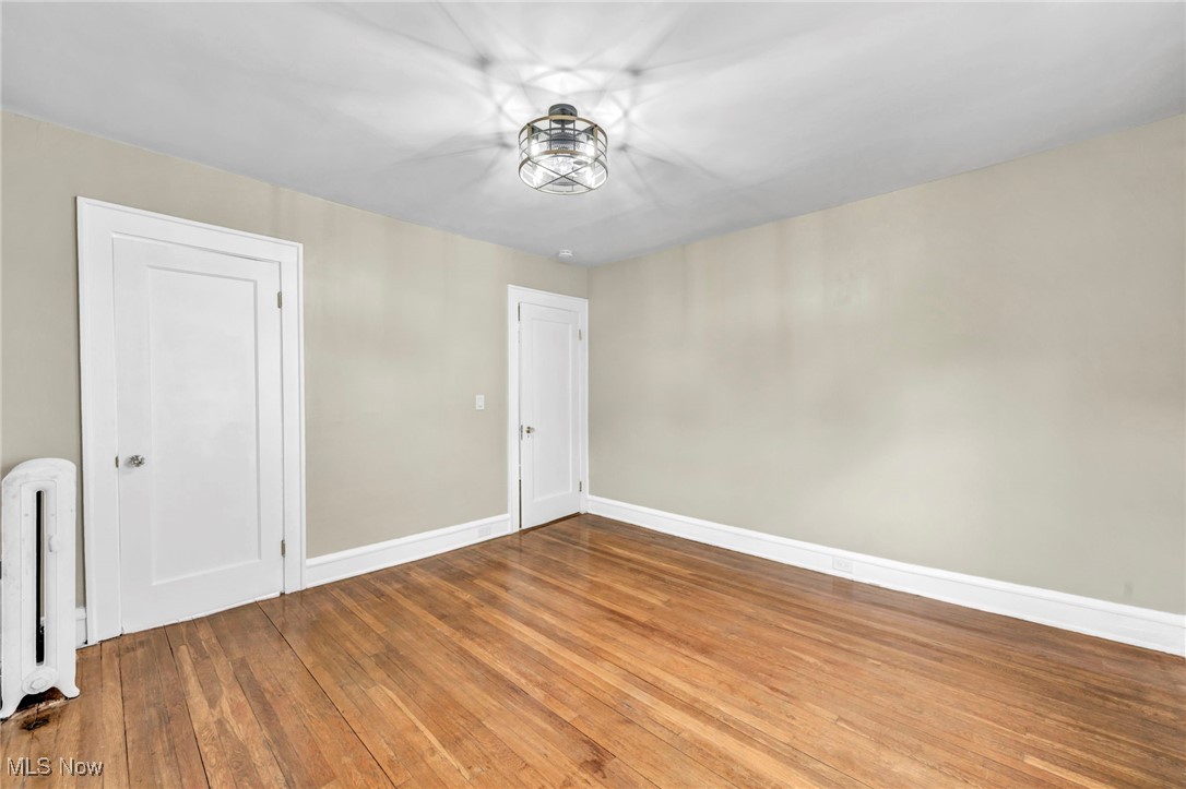 2980 East Overlook Road Cleveland, OH 44118 - Photo 28 of 49 Empty room with hardwood / wood-style floors and radiator