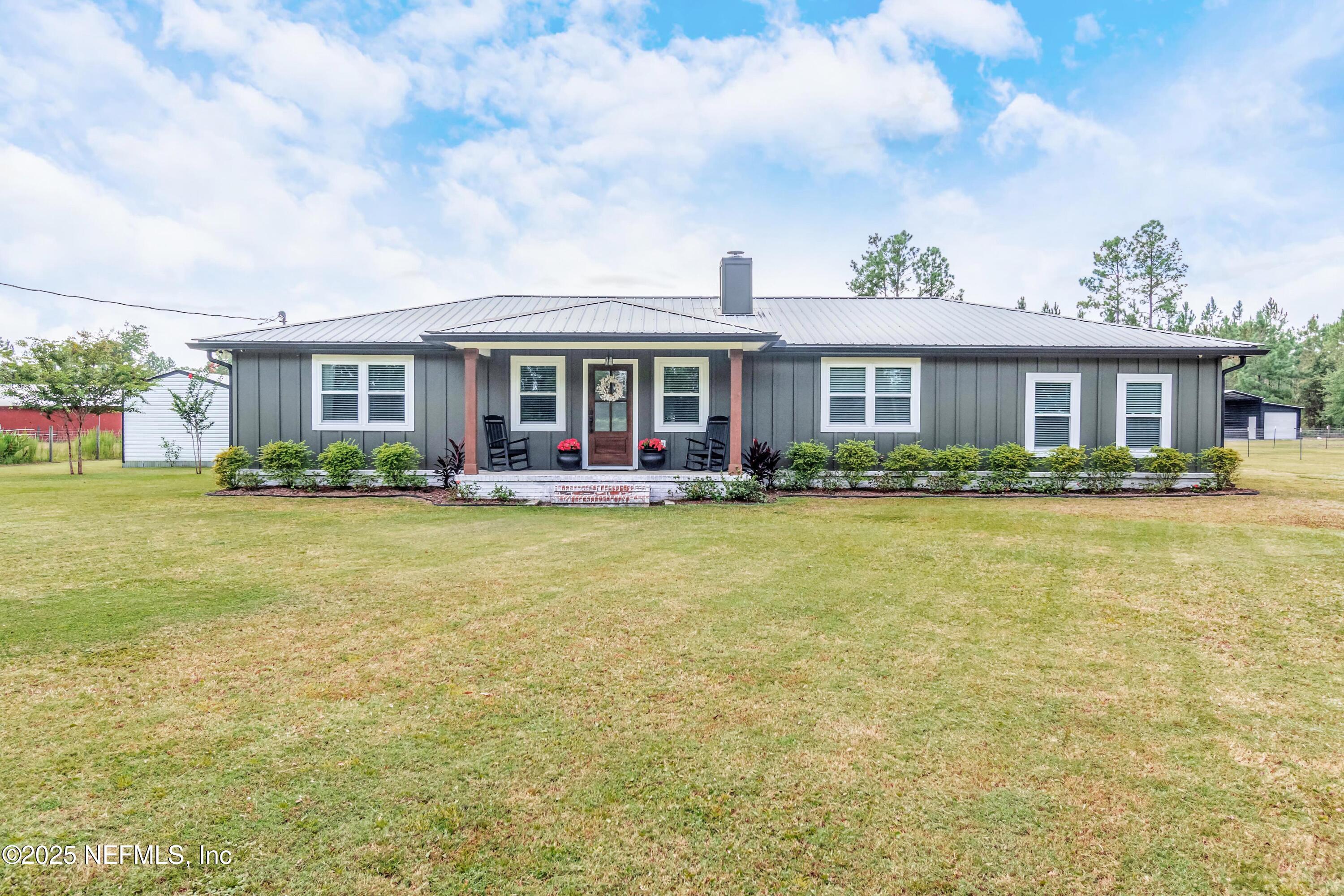 9100 Mud Lake Road Macclenny, FL 32063 - Photo 1 of 25 a front view of house with yard and outdoor seating