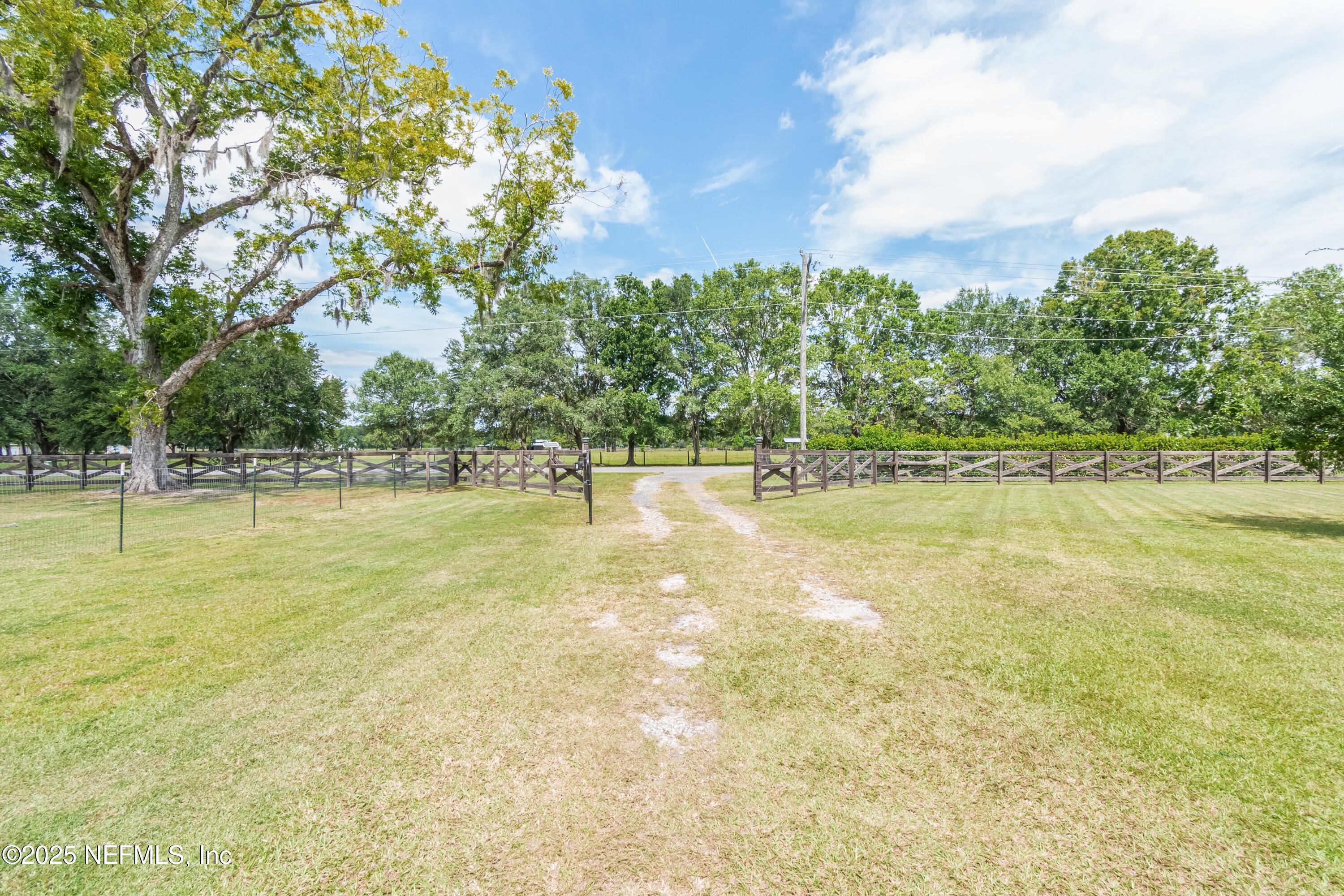 9100 Mud Lake Road Macclenny, FL 32063 - Photo 24 of 25 a view of a swimming pool with an outdoor space and seating area