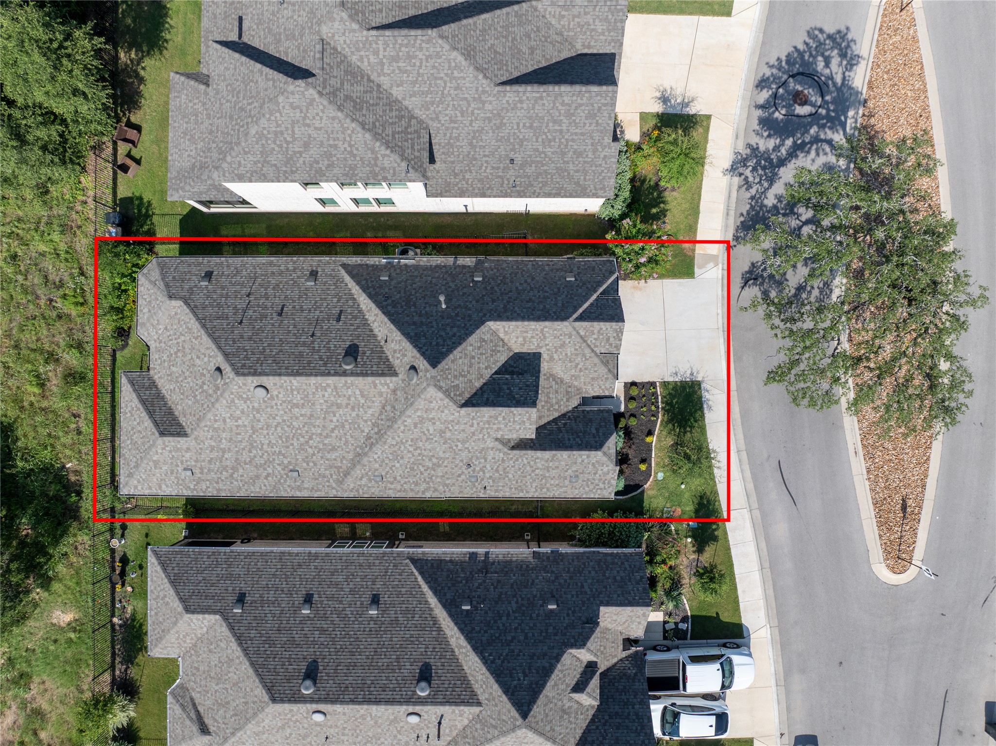 294 Kimble Creek Loop Kyle, TX 78640 - Photo 39 of 40 An aerial perspective showcases a well-maintained roofline amidst neighboring properties and a clean street.