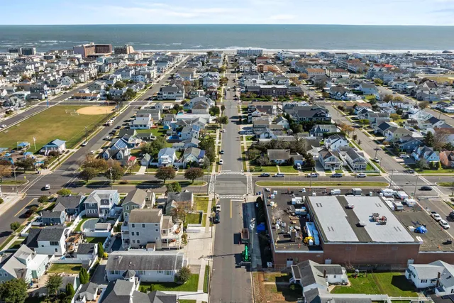 an aerial view of residential building and ocean