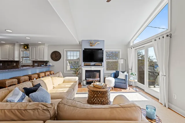 a living room with fireplace furniture and a flat screen tv