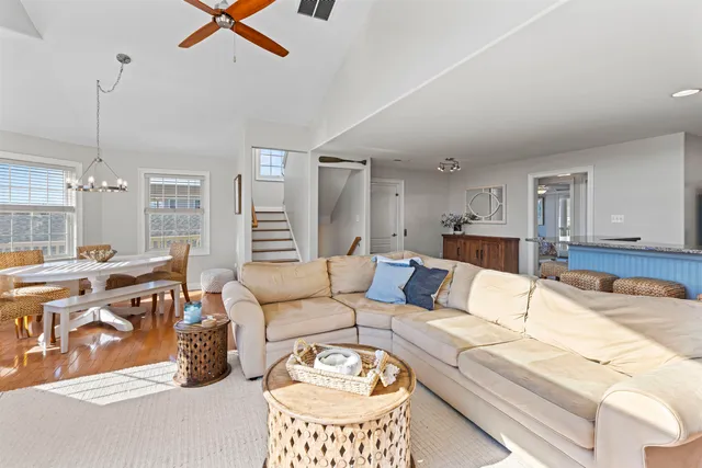 a living room with furniture a large window and a table